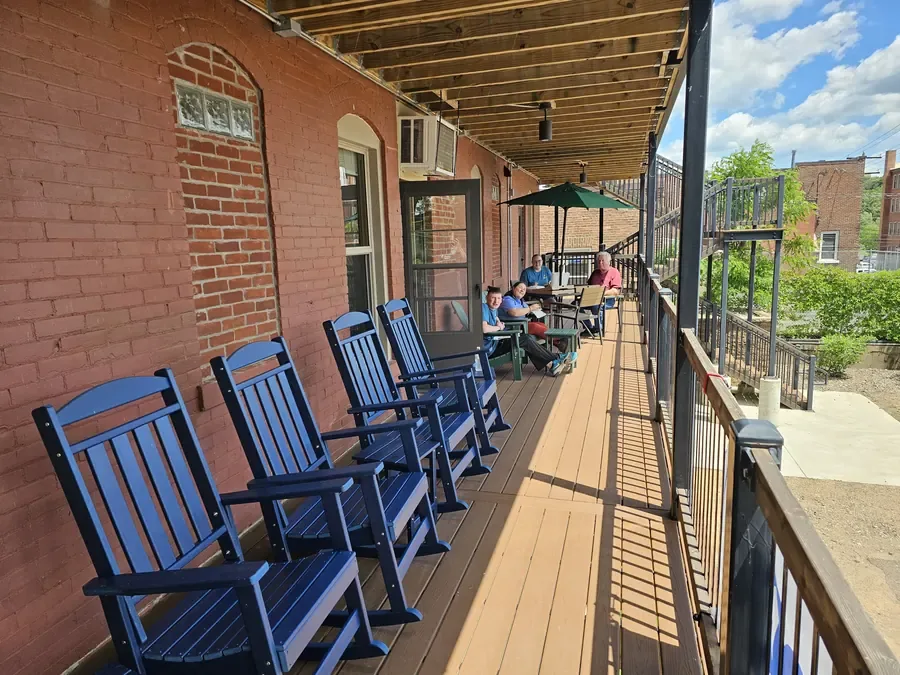 The Deck at Northwood Game Haven — riverside rocking chairs and river-view seating